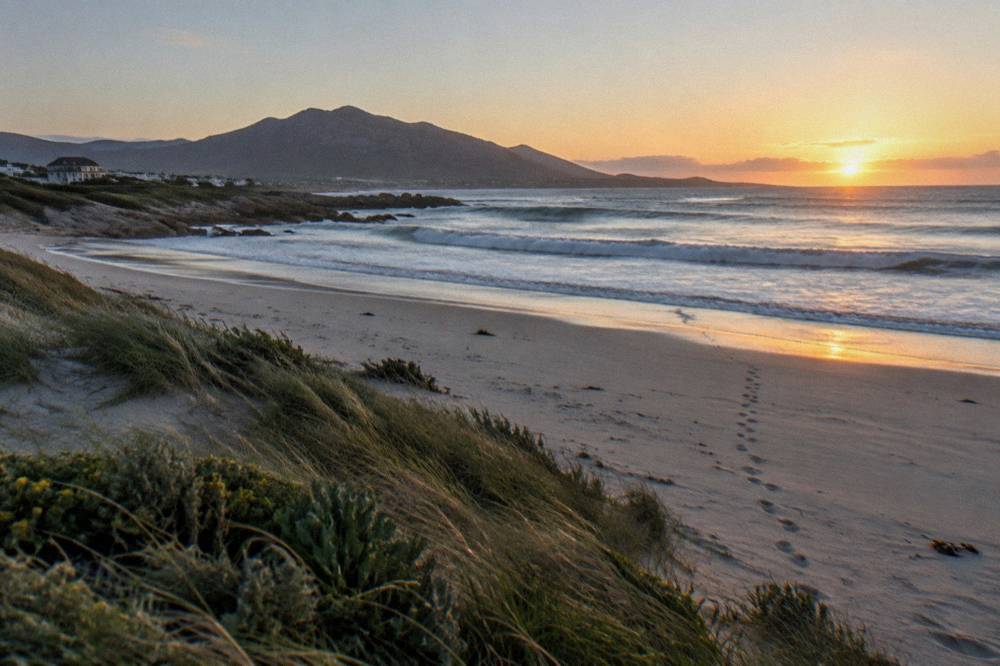An empty beach break at dawn with waves breaking along an unprotected South African shoreline